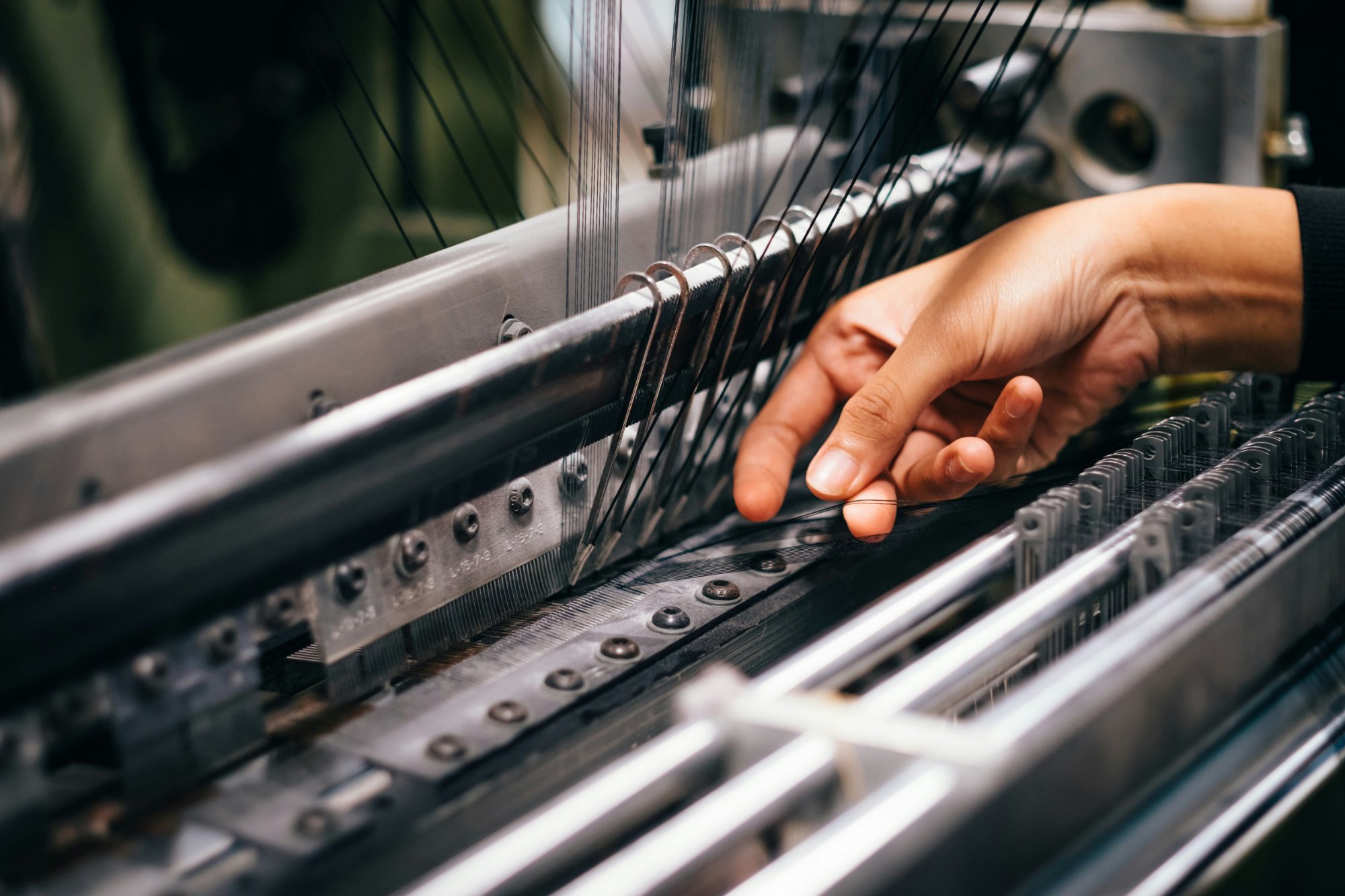 Craftsman's hand on a modern loom — Boonaj's production today